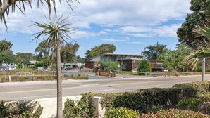 A modern building with a sign reading "State of California". - Eye Sea (Oceano)