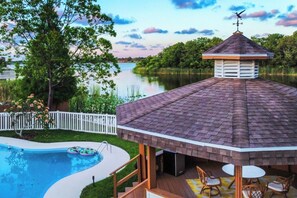A gazebo with a tiled roof, a pool, and a view of a lake. - Waterfront Heated Pool, Sleeps 22 - 4plex (Largo)