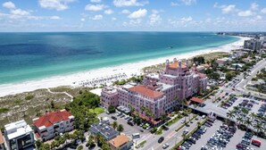 A coastal hotel with a beachfront view, multiple parking lots, and a mix of modern and traditional architecture. - Private Deck • Pet Friendly • Spacious Courtyard (St. Petersburg)