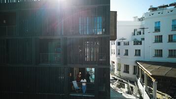 A multi-story building with balconies, a staircase, and a courtyard.