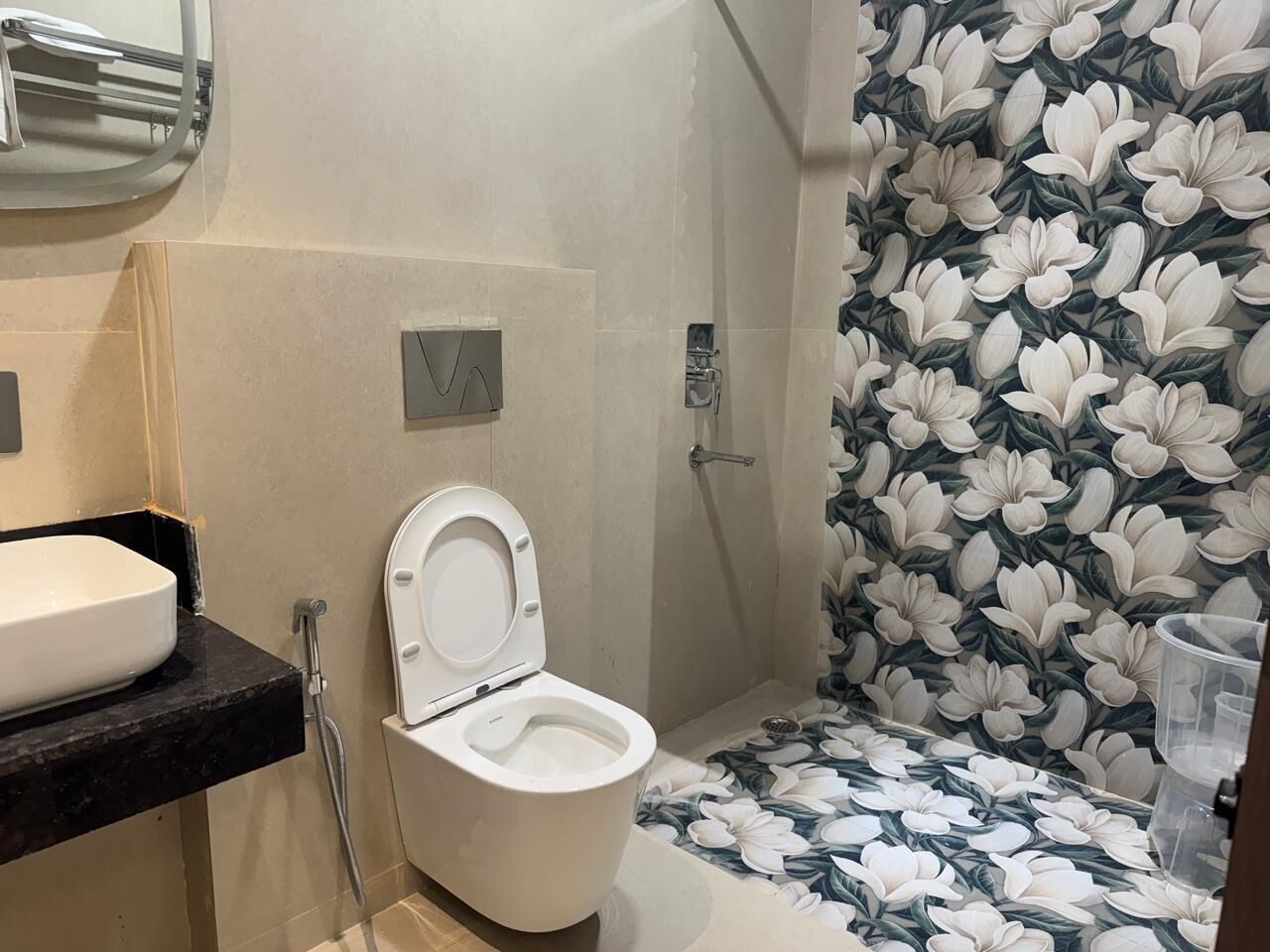 A bathroom with a toilet, a sink, and a shower.