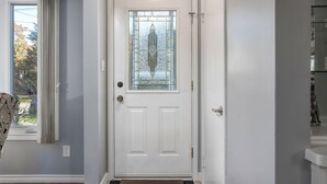 A white door with a glass panel and a doormat. - Comfortable 3 bedroom unit on a quiet street,close to downtown (Guelph)