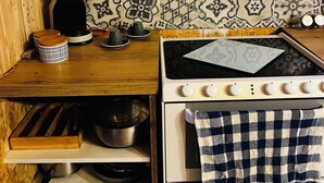 A kitchen with a wooden countertop, a coffee maker, a kettle, and a stove. - The Bubble Chalet  (Sainte-Marie-au-Bosc)