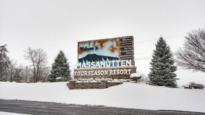 A sign for MASSANUTTEN FOUR SEASON RESORT with amenities like WaterPark, Golf Courses, Day Spa, Dining, and Snow Sports. - Woodstone Meadows 2 BR 2 BA Condo at Massanutten Resort (Massanutten)