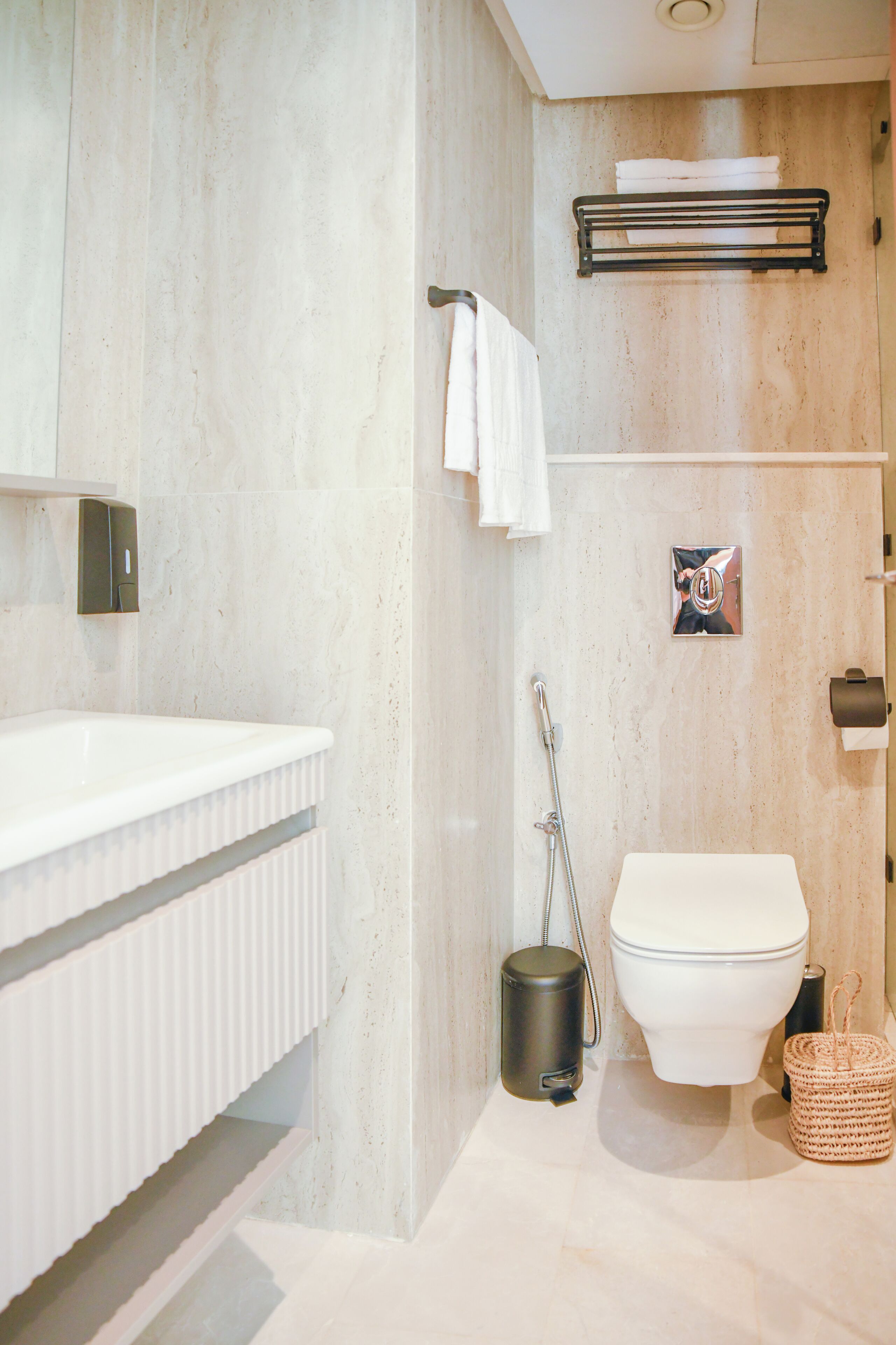 A bathroom with a white sink, toilet, and shower.