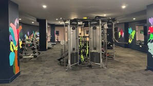 A gym with various exercise equipment, including weight machines and cardio machines. - Modern 2BR/2BTH near DC; Walk to Mall, Shops & Metro! (Hyattsville)