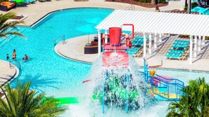 A swimming pool with a water slide, lounge chairs, and a covered area. - Ideal Family 5BR Villa in Windsor at Westside Resort ● Private Pool, BBQ & more! (Kissimmee)