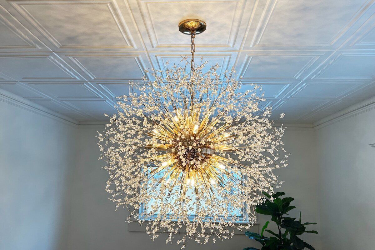 A chandelier with a starburst design hanging from the ceiling.