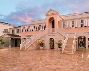 A building with a central staircase, a covered area, and a sign reading 'Town Hall'.