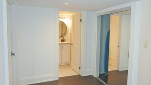 A hallway with white walls and wooden flooring leading to a bathroom with a blue shower. - Comfortable Mississauga Stay, Private Entry, Laundry & Wi-Fi (Mississauga)