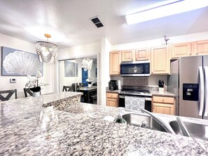 Paper towels, dining tables, kitchen islands - “Quiet Ground‑Floor 2BR/2BA • Pool • No Resort Fees” (Panama City Beach)
