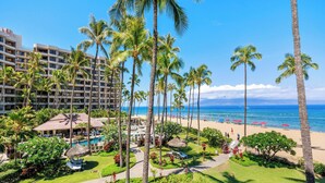 A resort with a pool area, palm trees, and a beach. - Wraparound Ocean Views | Sleeps 6 w/ Resort Amenities (Lahaina)