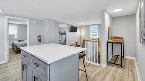 A modern apartment with a kitchen area, a dining space, and a bedroom. - Wildwood Waves - 2BR Apt - Steps from Beach (Wildwood)
