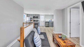 A modern apartment with a living room, dining area, and kitchen. - Wildwood Waves - 2BR Apt - Steps from Beach (Wildwood)