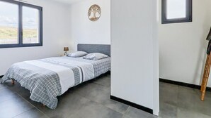 A bedroom with a bed, a nightstand, a lamp, a wall-mounted tree decoration, and a window. - Cozy home in Saint Germain sur Ay with WiFi (Saint Germain sur Ay)