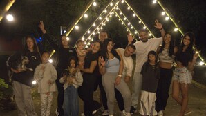 A group of people posing in front of a decorative light installation at night. - Ecohotel El Castillo Pance (Cali)