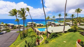A resort with a pool, palm trees, and ocean views. - Kapalua Bay | Ocean View 4 BR, Sleeps 14 | Car Incl. w/ 6+ Nights | KBV ML-2068 by KBM (Lahaina)