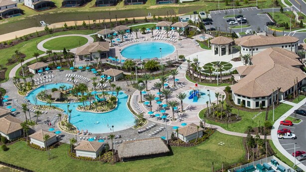 An aerial view of a resort with multiple swimming pools, sun loungers, and a central water slide. - Modern Oasis Near Shopping n Golf Course w Pool (Davenport)