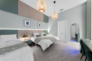 A modern bedroom with two beds, a desk, and a mirror. - Brand New Modern State of the Art Home Sleeps 31 (Kissimmee)