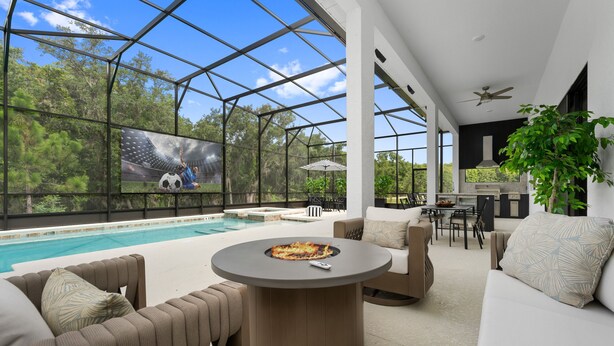 A modern outdoor living area with a pool, seating, and a fire pit. - Brand New Modern State of the Art Home Sleeps 31 (Kissimmee)