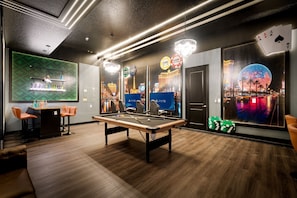 A pool table in a room with a view of Las Vegas, including the Eiffel Tower and the MGM Grand. There are poker chips and a card game setup. - Brand New Modern State of the Art Home Sleeps 31 (Kissimmee)