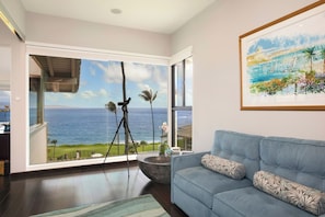 A living room with a large window overlooking the ocean, a telescope, and a framed painting of a tropical scene. - Kapalua Bay | Ocean View 4 BR, Sleeps 14 | Car Incl. w/ 6+ Nights | KBV ML-2080 by KBM (Lahaina)