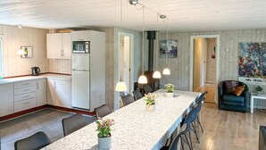 A modern kitchen with a central island, white cabinetry, and pendant lighting. - Lovely home in Væggerløse with sauna (Væggerløse)