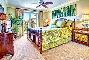 A spacious bedroom with a large bed, a ceiling fan, a view of the outside, and a painting on the wall. - Honua Kai | Ocean Front 3 BR | Free Car w/ 6+ Nights | HKH-501 (Lahaina)