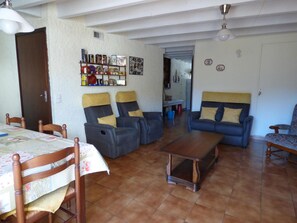 A living room with a dining table, two sofas, and a coffee table.