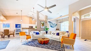 A spacious living room with a large coffee table, two sofas, and a dining area with chairs. - Coastal Haven in Sebastian W/ Heated Saltwater Pool, BBQ Grills, Fire Pit & Near Beaches!🌴 (Sebastian)