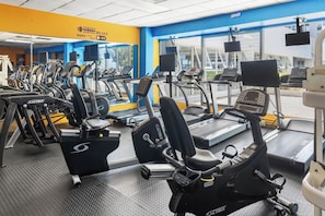 A gym with multiple cardio machines, including treadmills and elliptical trainers, arranged in rows. - Beachfront King Suite • Pool • Parking• Walk2Eat (Carolina)