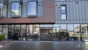 A modern building with a glass facade, a sign reading "THE POINT," and a welcoming entrance. - The Point 922 - Grampian Lettings (Aberdeen)