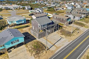 A coastal residential area with houses, a road, and a beach. - Babe's Place | 105 ft to the beach | Dog Friendly (Kill Devil Hills)