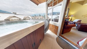 A hot tub on a balcony with a view of snow-covered mountains. - Settler's Crossing Condo with Views of Tod Mountain! (Sun Peaks)