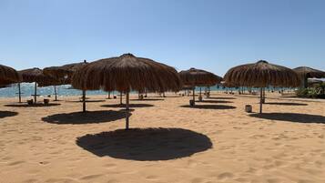 On the beach, sun loungers, beach towels