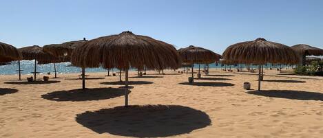 On the beach, sun loungers, beach towels