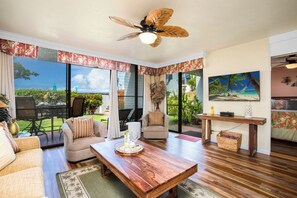 With palm-framed valances, earthy tones, and lanai access, this living room invites leisure with a wink of aloha    NAP-A25 - Napili Point | Oceanfront 2 BR, Sleeps 8 | Car Incl. w/ 6+ Nights | NAP ML-2490 by KBM (Lahaina)
