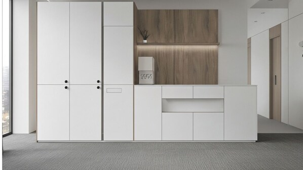 A modern, minimalist room with a large wardrobe, a small desk, and a wooden accent wall. - GOYOJAE HOTEL (Suwon)