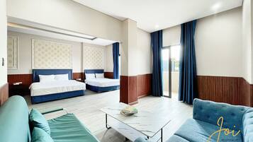 Habitación familiar, balcón, vista a la playa | Escritorio, espacio para trabajar con laptop y cortinas blackout