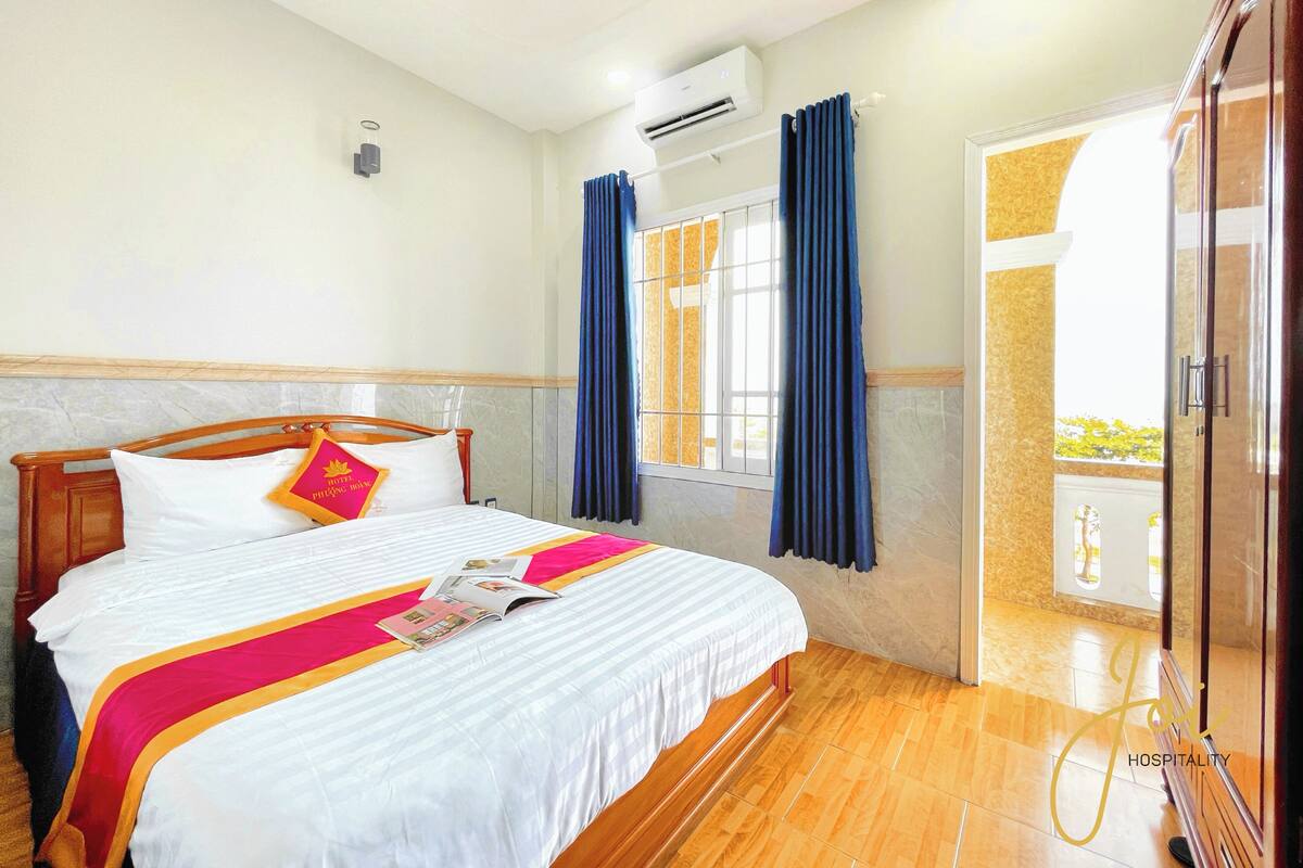 Deluxe Double Room, Balcony, Beach View | Desk, laptop workspace, blackout drapes, iron/ironing board