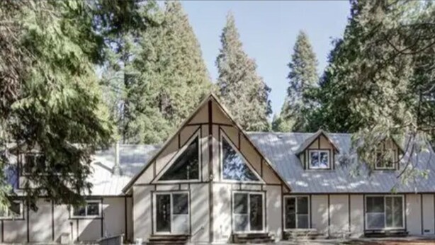 A modern house with a symmetrical facade, large windows, and a prominent triangular gable. - Charming 3-bedroom country house with AC in Shingletown (Shingletown)