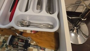 Un tiroir de cuisine contenant des ustensiles et un ensemble de couteaux.