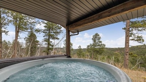 A hot tub with a view of a forested landscape. - MK Hideaway Mountain Cabin w/ Hot Tub (Lead)