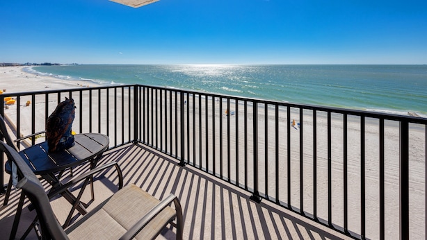 Ein Balkon mit Blick auf Strand und Meer.