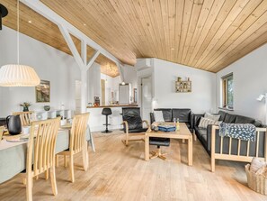 A spacious living area with a wooden ceiling, a dining table with chairs, a sofa, and a coffee table. - "Jaane" - 250m to the fjord by Interhome (Vestervig)