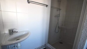 A bathroom with a white sink, a glass shower enclosure, and a handrail. - Dbac23 - 3 Bedroom Apartment - Balcony - Sleeps 8 - 1800 Area (Puy-Saint-Vincent)