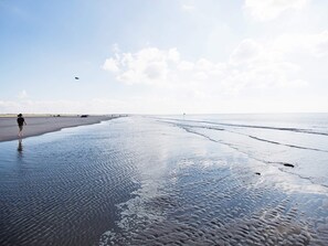 A beach with wet sand and a person walking. - Inviting Holiday Home in Fano (Fano)