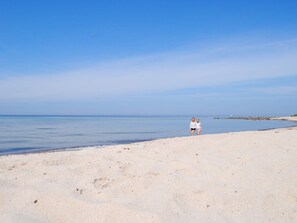 A beach with a clear sky and calm sea. - 6 Person Holiday Home in Hasle (Hasle)