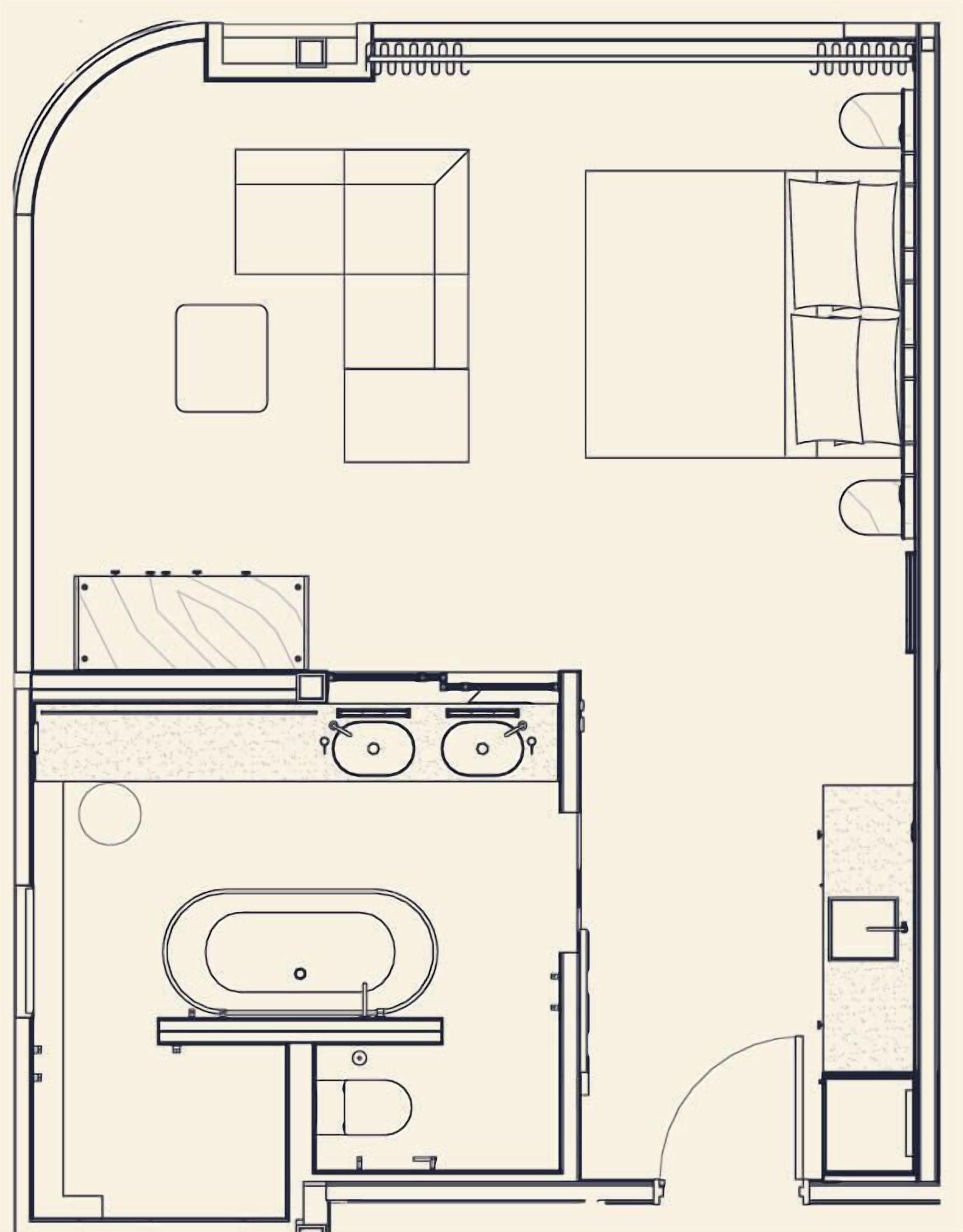 Un plan d’étage d’une chambre d’hôtel comprenant un lit, une salle de bain, un coin salon et une kitchenette.