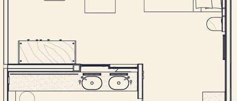 A floor plan of a hotel room with a bed, a bathroom, a sitting area, and a kitchenette.